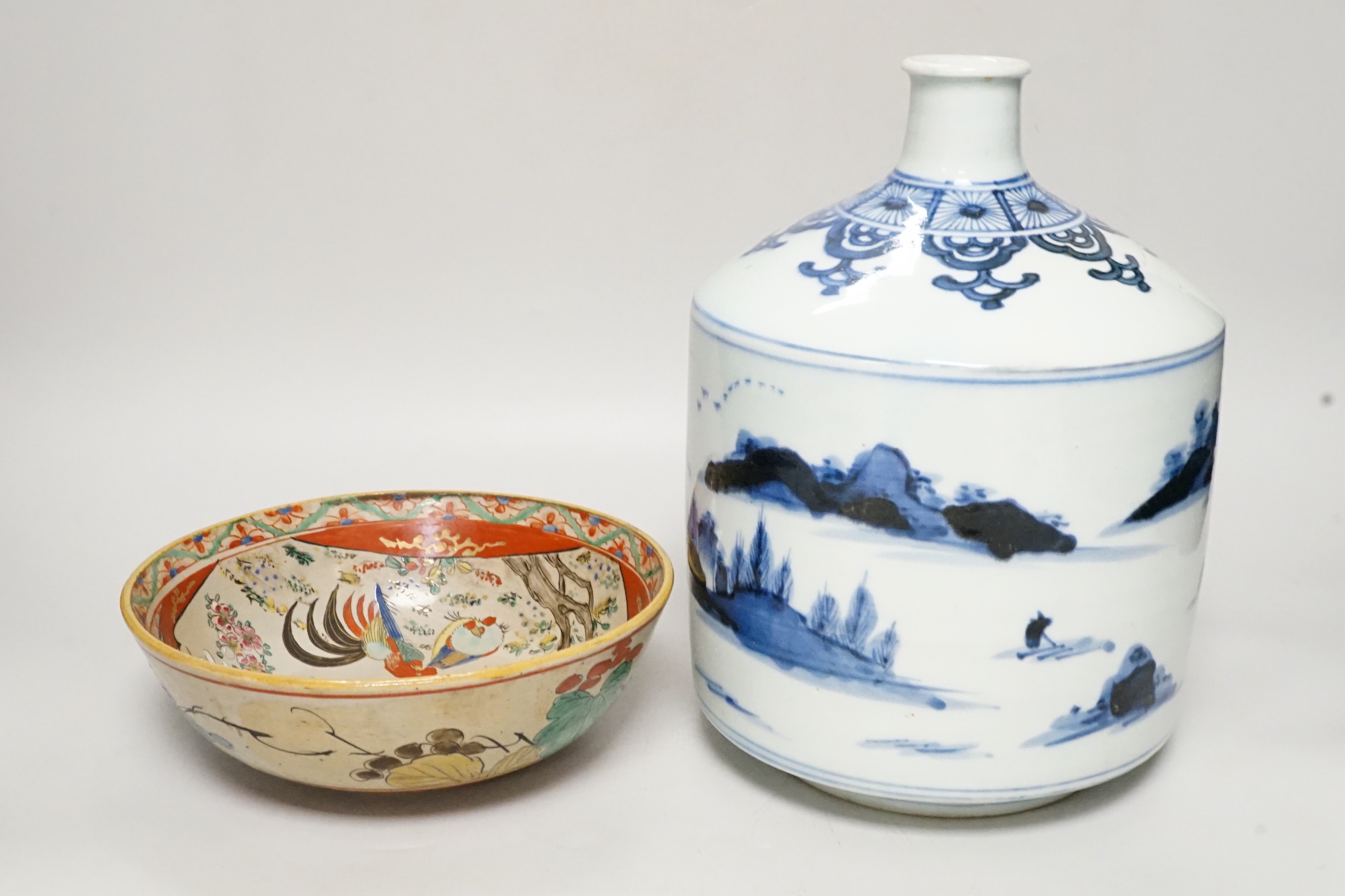 A large Japanese Arita blue and white sake flask and a Kutani bowl, largest 26cm tall